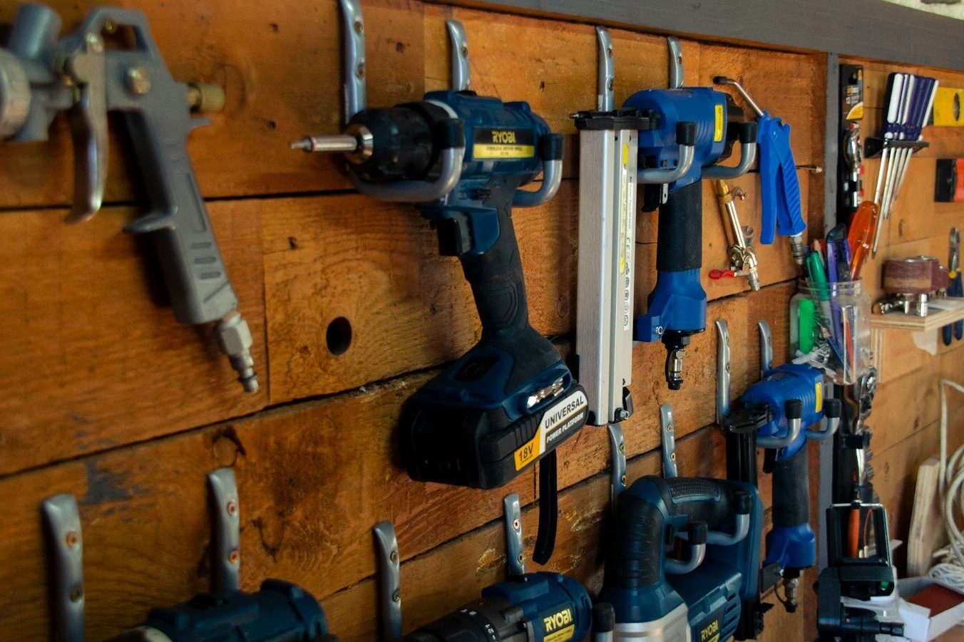 a bunch of tools are hanging on a wall