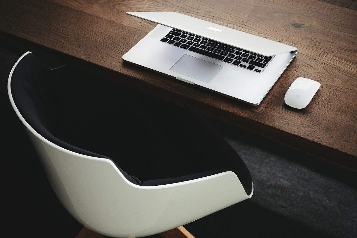 Apple MacBook beside computer mouse on table